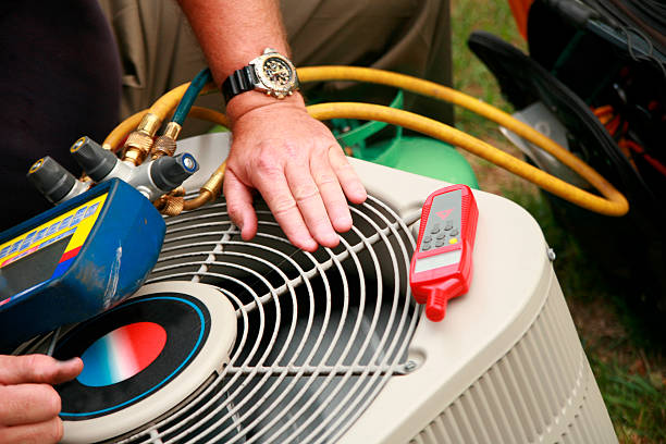 HVAC technician repairing an AC unit