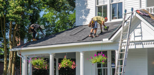 Belmont, North Carolina, USA - June 3, 2018: Roofing contractors replace roofs on residents’ homes in Belmont, North Carolina after a hail storm moved through the area on April 15, 2018. Golfball-sized hail was wide-spread and caused much property damage–especially to roofs. Roofing contractors are working seven days a week in temperatures over 90 degrees to meet demand from homeowners. Even at this rate, it could take several years to replace all of the roofs which received damage from the storm.